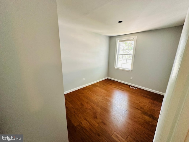 spare room featuring hardwood / wood-style flooring