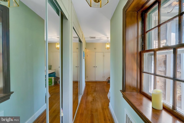 corridor with wood-type flooring