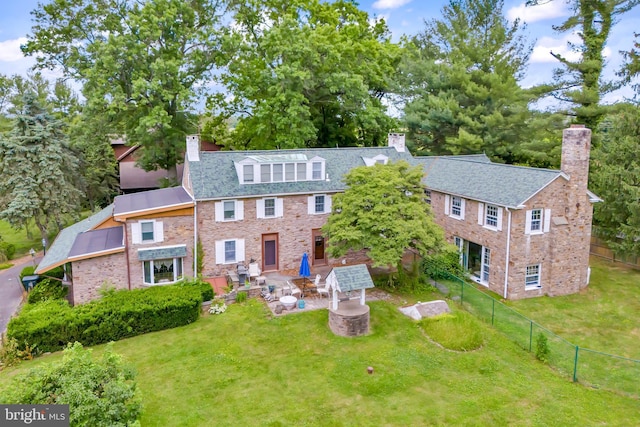 view of front of house with a patio and a front yard