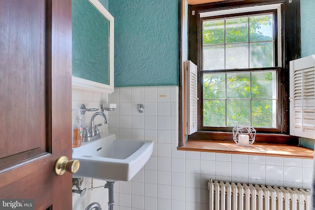 bathroom with sink and radiator