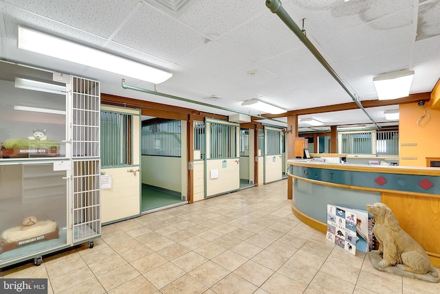 kitchen featuring a drop ceiling and light tile patterned floors