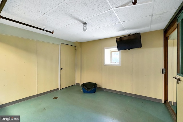 basement with a paneled ceiling