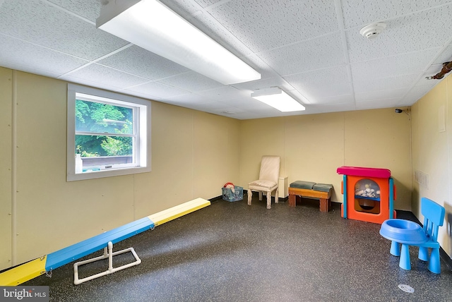 recreation room with a drop ceiling