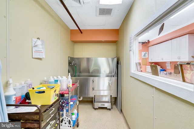 kitchen with white cabinets and stainless steel fridge