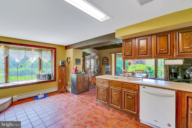 kitchen with dishwasher, light tile patterned flooring, sink, and a baseboard radiator