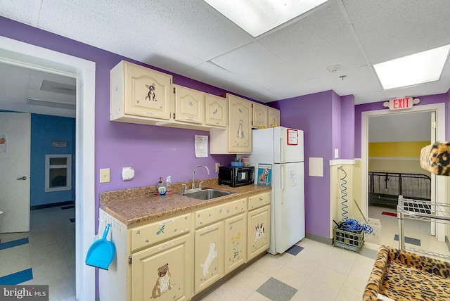 kitchen featuring sink, a drop ceiling, and white refrigerator