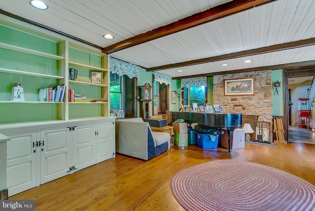 living area with beam ceiling and light hardwood / wood-style floors