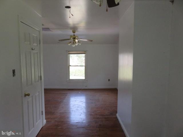 spare room featuring ceiling fan and dark hardwood / wood-style flooring