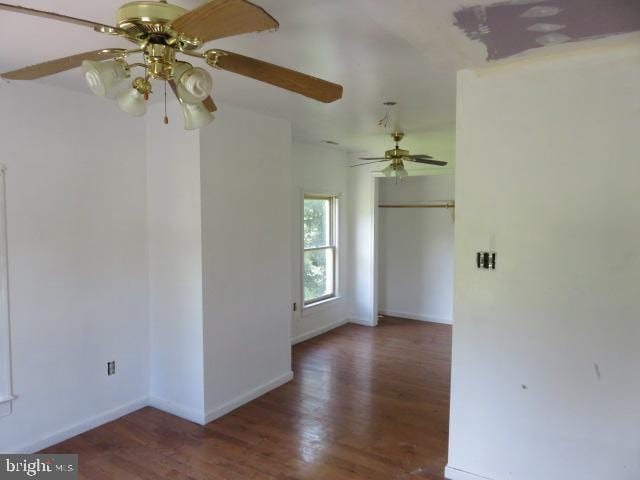 unfurnished room featuring dark wood-type flooring