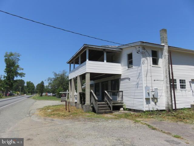 back of property featuring covered porch