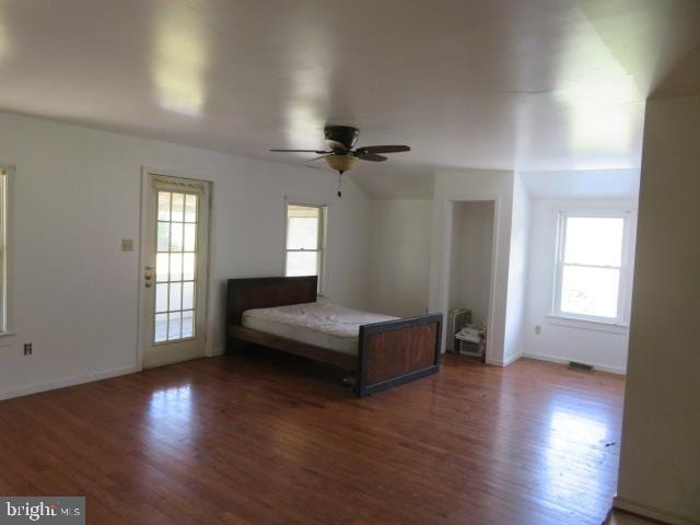 unfurnished bedroom featuring dark hardwood / wood-style flooring and ceiling fan