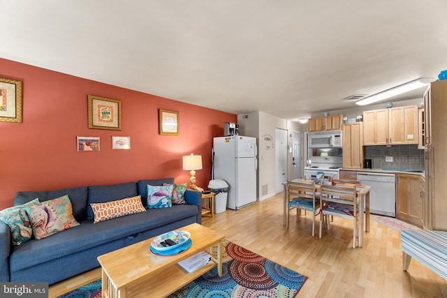 living room with light hardwood / wood-style flooring