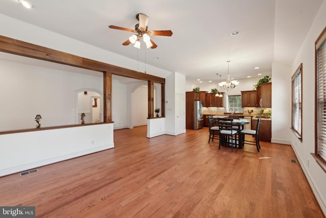 interior space featuring wood-type flooring and ceiling fan with notable chandelier