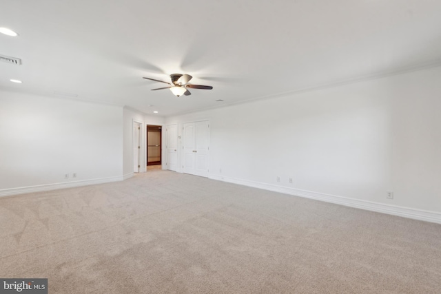 carpeted spare room with ceiling fan