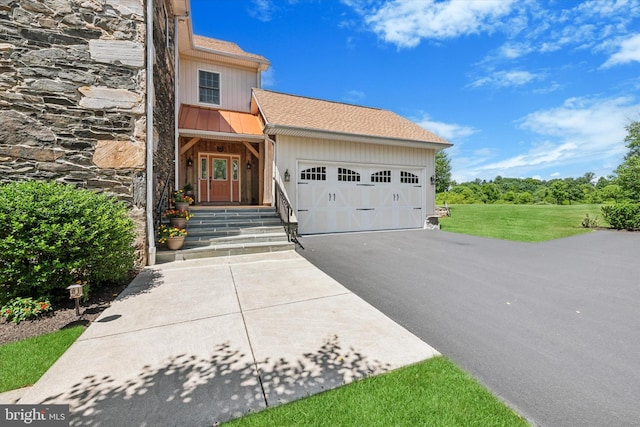 view of front facade with a front yard and a garage