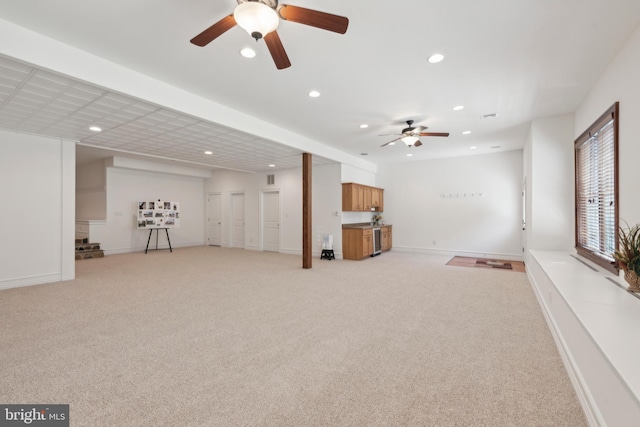 interior space with ceiling fan and light colored carpet