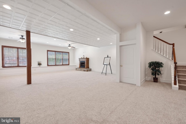 unfurnished living room with light carpet and ceiling fan