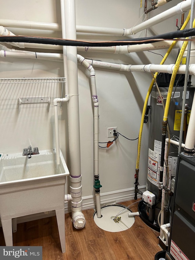 utility room featuring sink and water heater