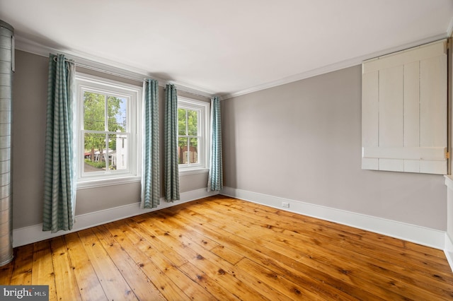 unfurnished room featuring hardwood / wood-style flooring and ornamental molding