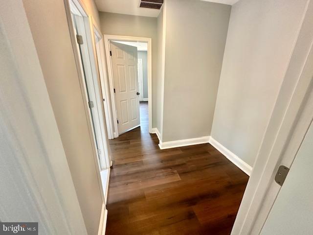 hall with dark hardwood / wood-style flooring