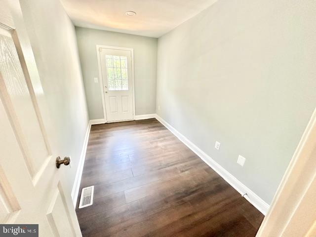 doorway featuring dark wood-type flooring