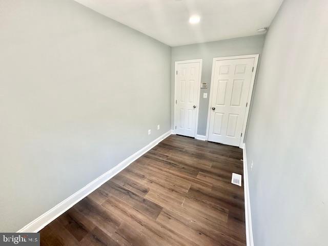 spare room featuring dark hardwood / wood-style floors