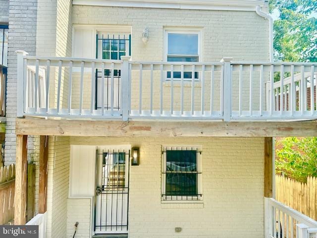 rear view of property featuring a balcony