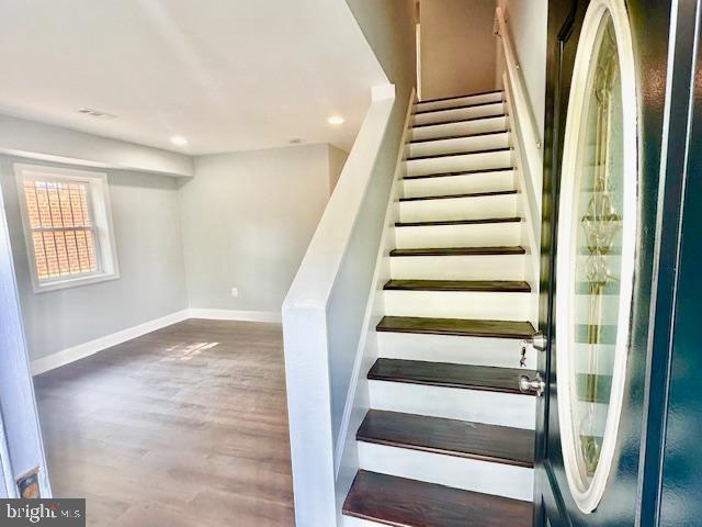 stairway featuring hardwood / wood-style flooring