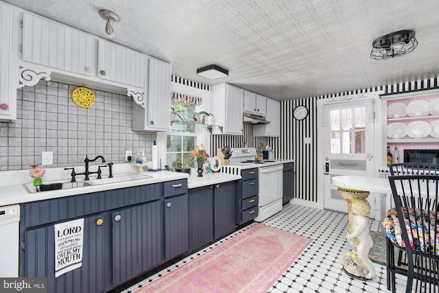 kitchen with sink, white cabinetry, white appliances, backsplash, and blue cabinets