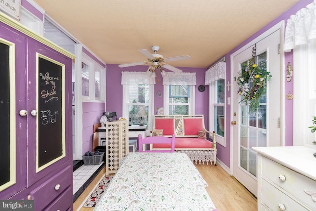 sunroom featuring ceiling fan