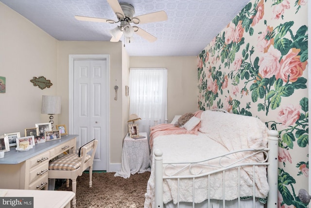 carpeted bedroom with a closet and ceiling fan