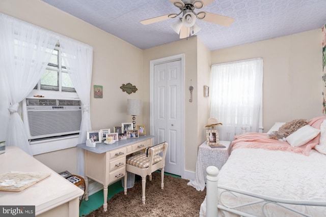 bedroom featuring a closet, ceiling fan, carpet flooring, and a textured ceiling