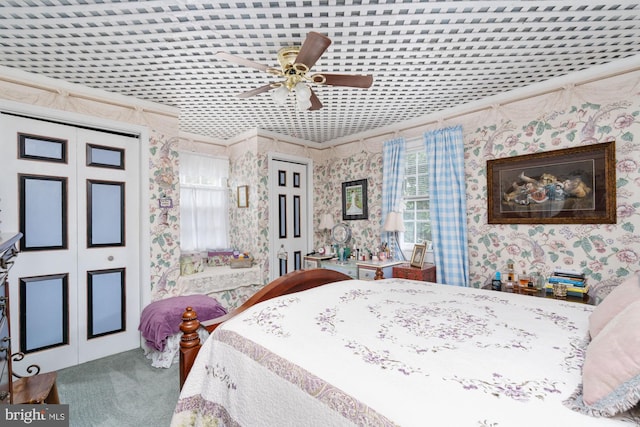 carpeted bedroom featuring crown molding and ceiling fan