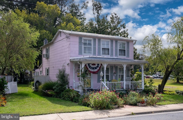 view of front of home with a front yard and a porch