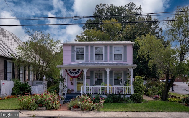 view of front of property with a front yard and covered porch