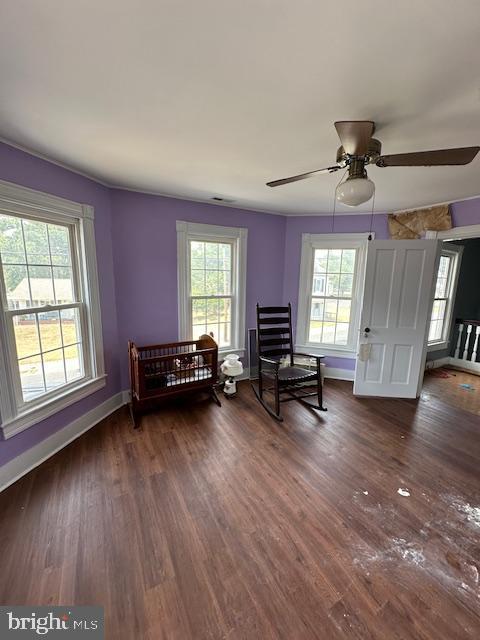 unfurnished room featuring ceiling fan and dark wood-type flooring