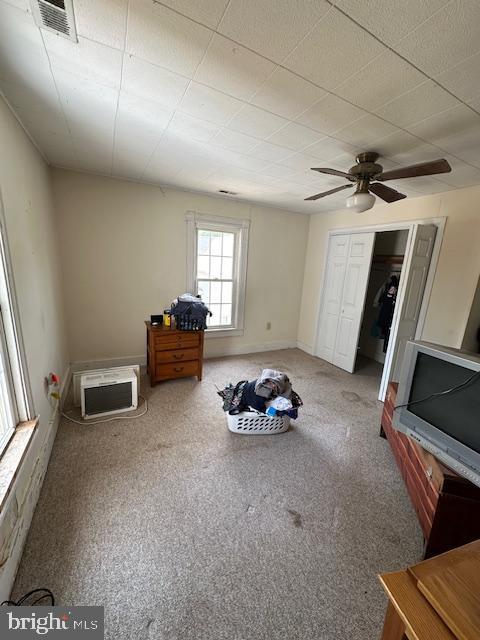 interior space featuring ceiling fan, a closet, and carpet