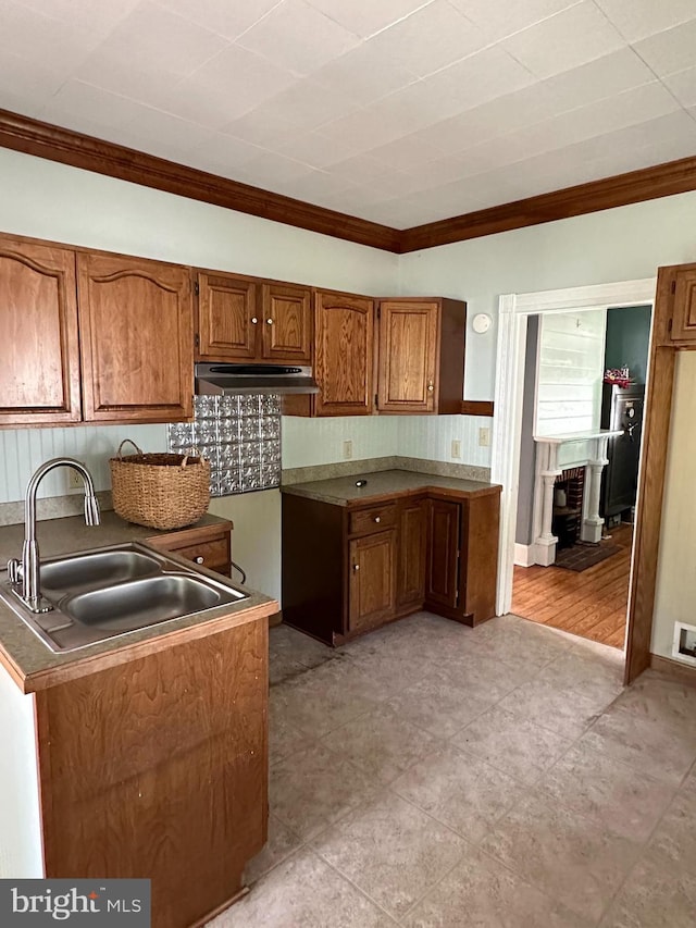 605 State St, Sharptown, MD 21861 - kitchen featuring crown molding, brown cabinets, under cabinet range hood, and light tile patterned floors