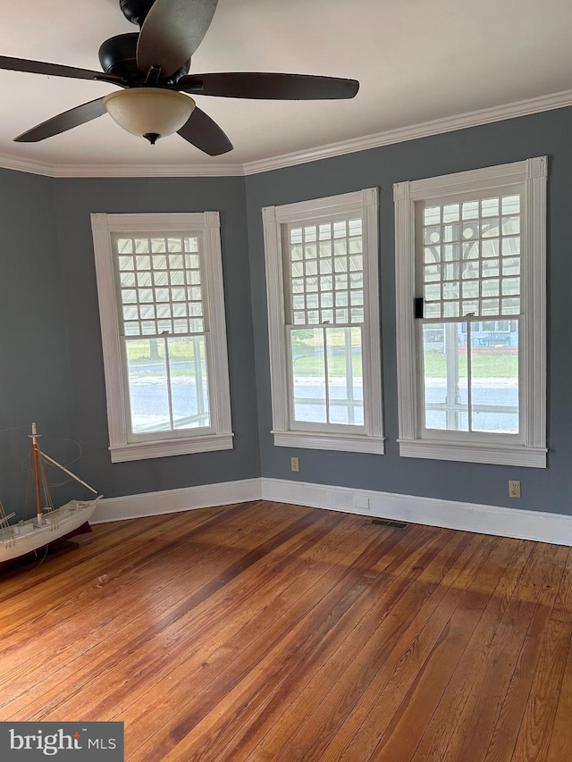 605 State St, Sharptown, MD 21861 - unfurnished room featuring healthy amount of natural light, hardwood / wood-style flooring, ceiling fan, and ornamental molding