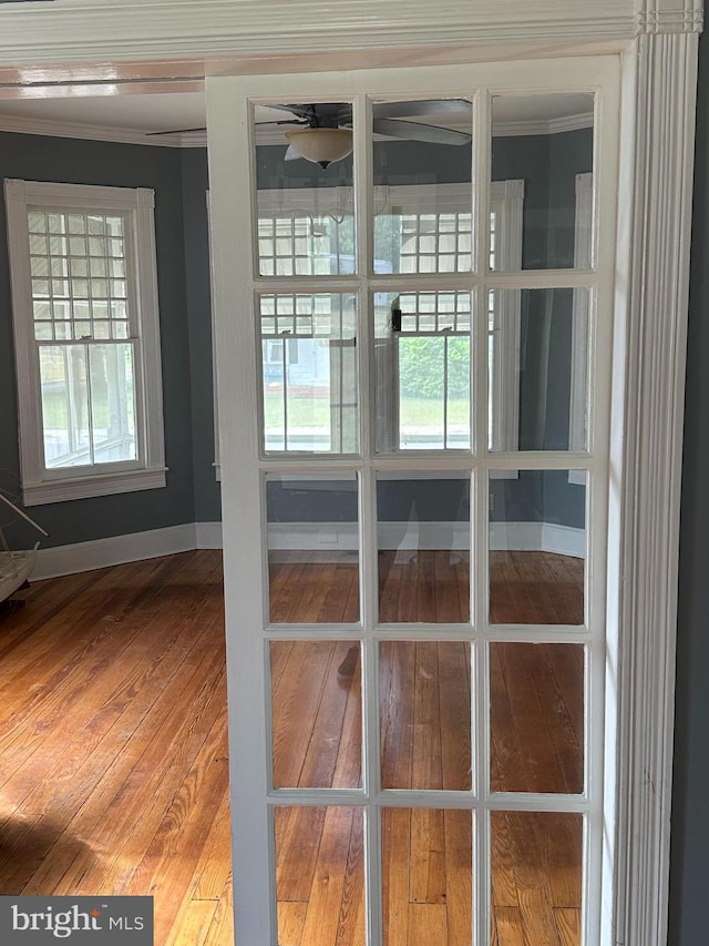 interior details with hardwood / wood-style flooring, ceiling fan, and ornamental molding