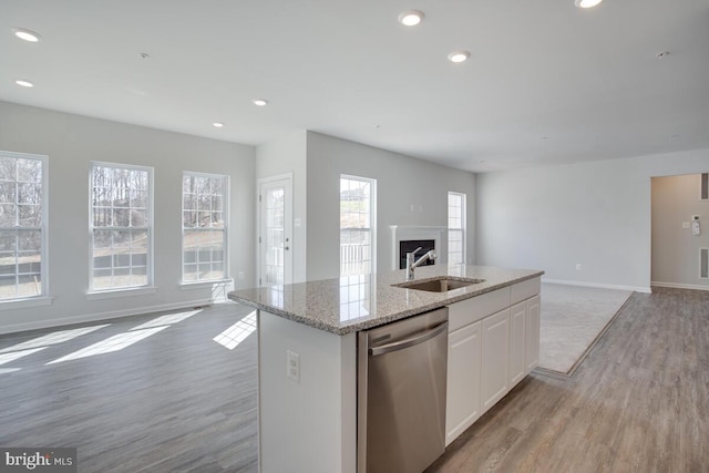 kitchen with white cabinetry, stainless steel dishwasher, a healthy amount of sunlight, and sink