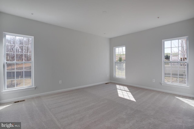 carpeted empty room featuring a healthy amount of sunlight