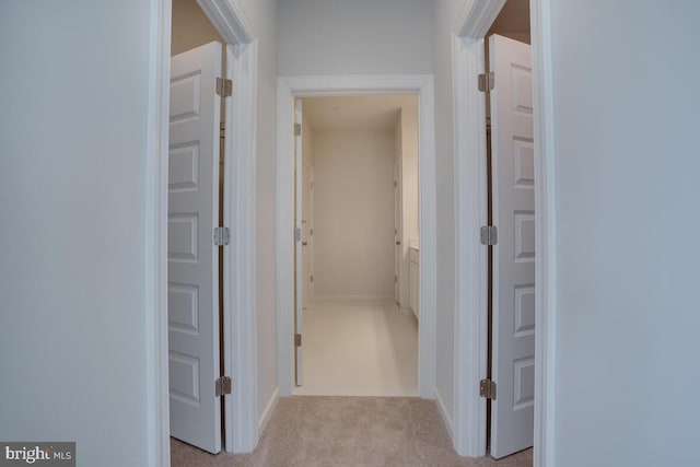 hallway featuring light carpet