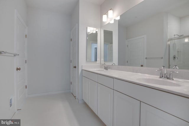 bathroom with tile patterned flooring, vanity, and a shower with door