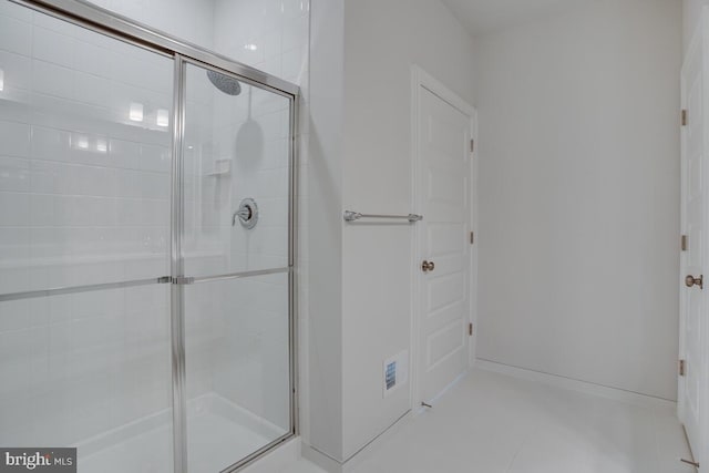 bathroom featuring tile patterned flooring and an enclosed shower