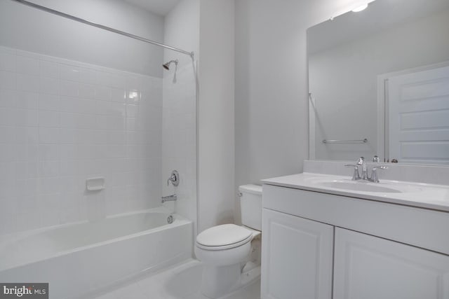 full bathroom with tile patterned floors, vanity, tiled shower / bath combo, and toilet