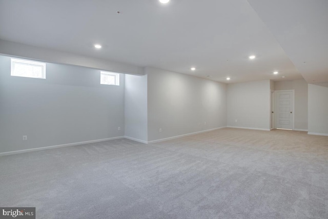 basement featuring light carpet and plenty of natural light