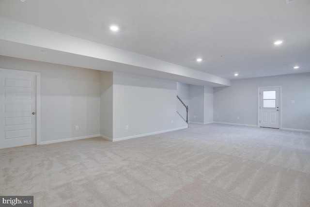 basement featuring light carpet