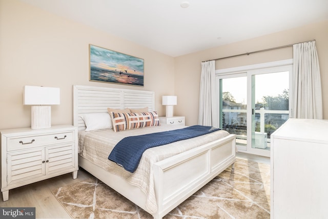 bedroom with light wood-type flooring and access to outside