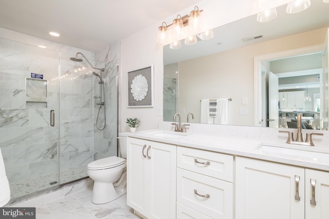 bathroom with an enclosed shower, vanity, and toilet